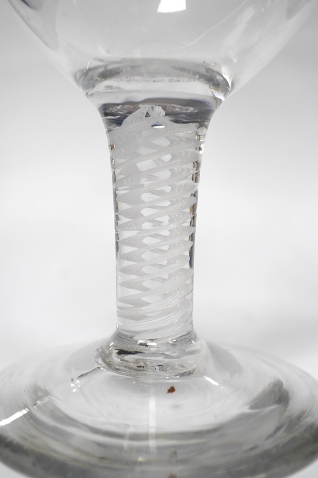 A DSOT stem goblet, circa 1765, with a cup shaped bowl, diamond point engraved ‘J Edden’and a facet stem wine glass, circa 1770, the round funnel bowl engraved with fruiting vines a chrysanthemum and a moth, 15.3cm and 1